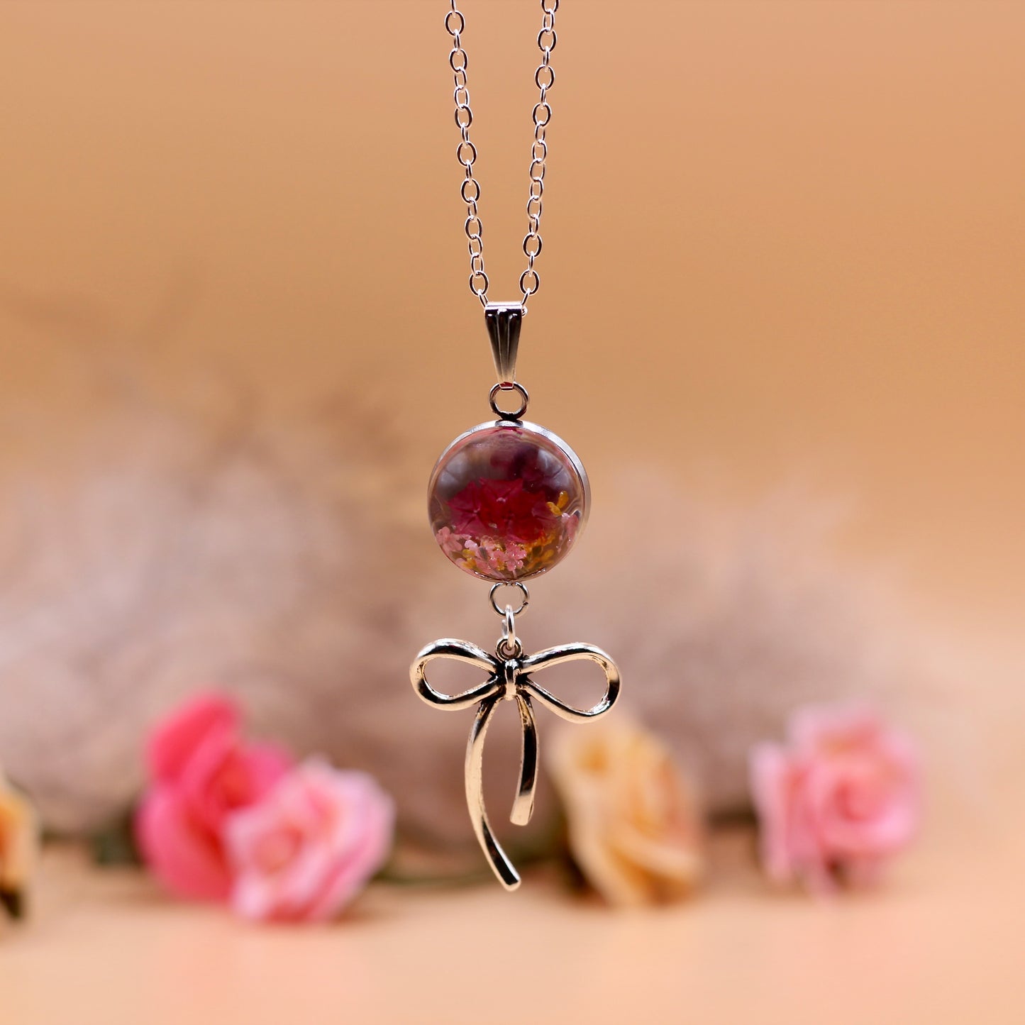 Ketting roze bloemen met strik